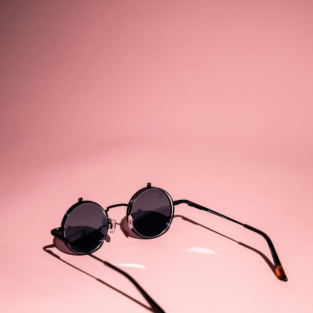Sunglasses on pink background
