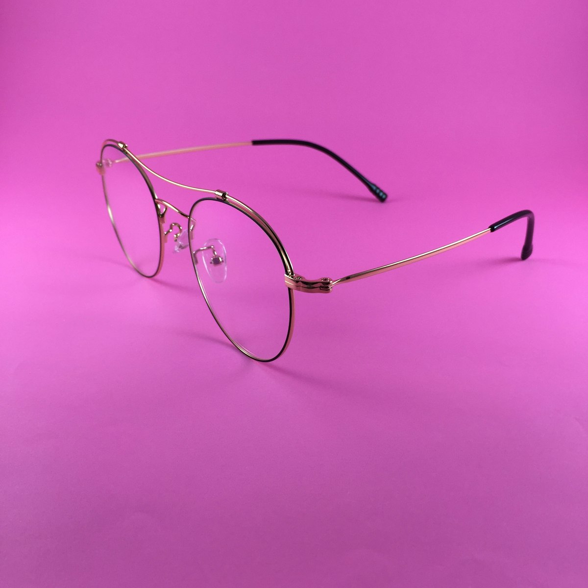 Prism oval metal eyeglasses on pink