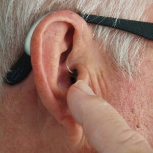 Behind-the-ear hearing aid being worn